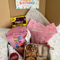 Happy Birthday Box featuring pink dog birthday slice toy, birthday bandana in pink, Belle's Barkery Barkcuterie Box, and birthday hat