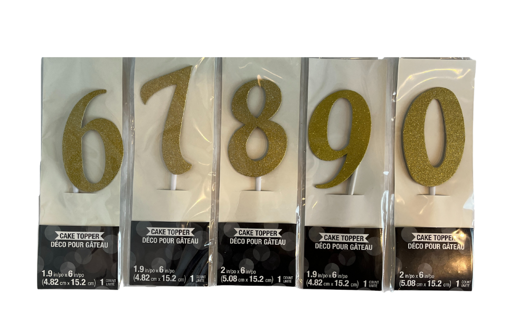 Gold number cake toppers in packaging. Numbers 6, 7, 8, 9, and 0 are shown.