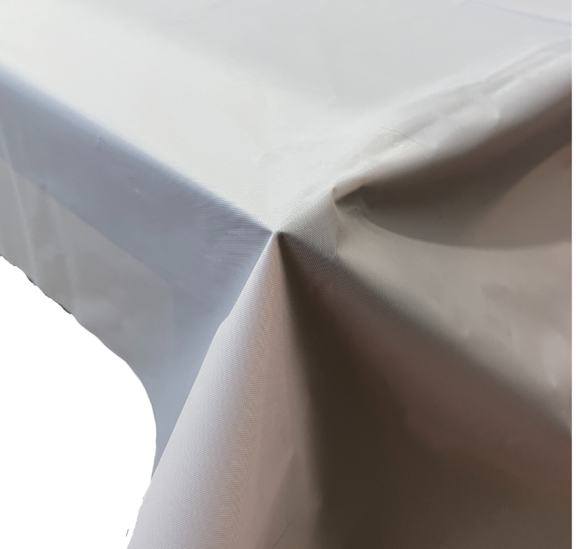 Corner of table covered with pink plastic table cover