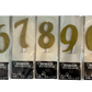 Gold number cake toppers in packaging. Numbers 6, 7, 8, 9, and 0 are shown.